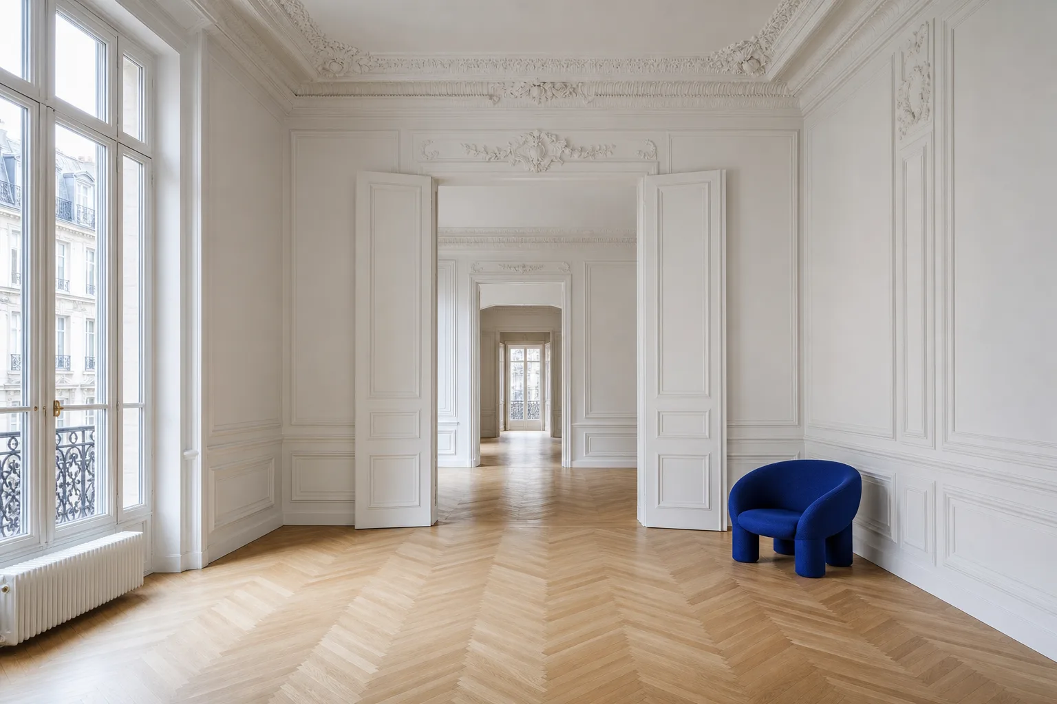 Bright flat for sale: large glass wall, herringbone parquet, a cobalt blue chair