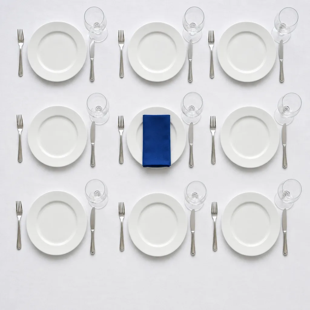Neatly laid banquet table, one cobalt blue linen napkin